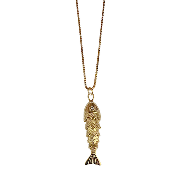 Gold fish-shaped pendant on a chain against a white background